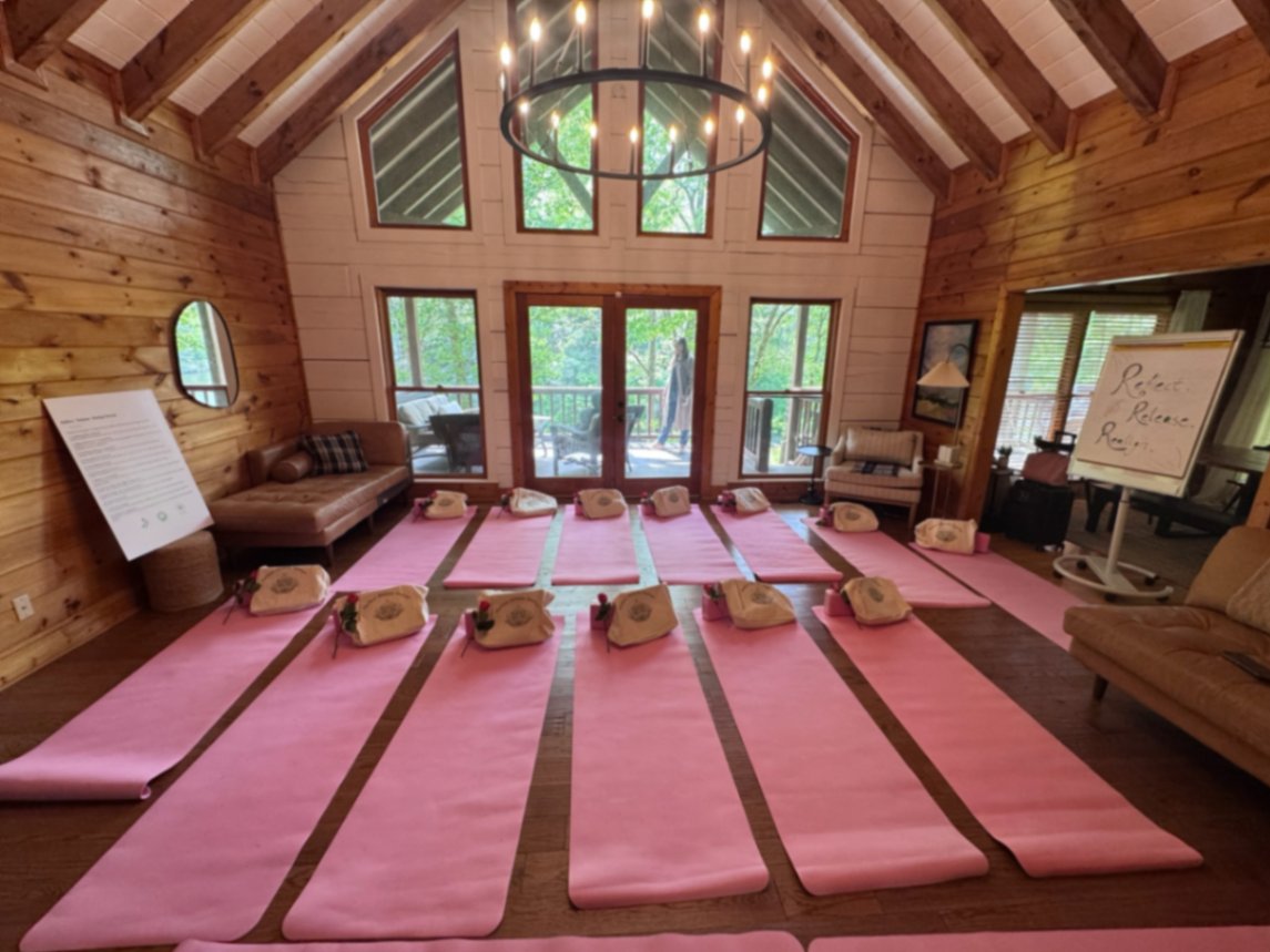 Retreat room prepared with pink mats, roses, and Reflect Release Realign easel