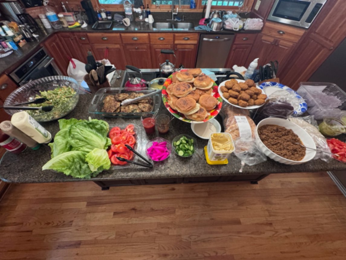 Shared kitchen counter set with home-cooked food for the retreat cohort